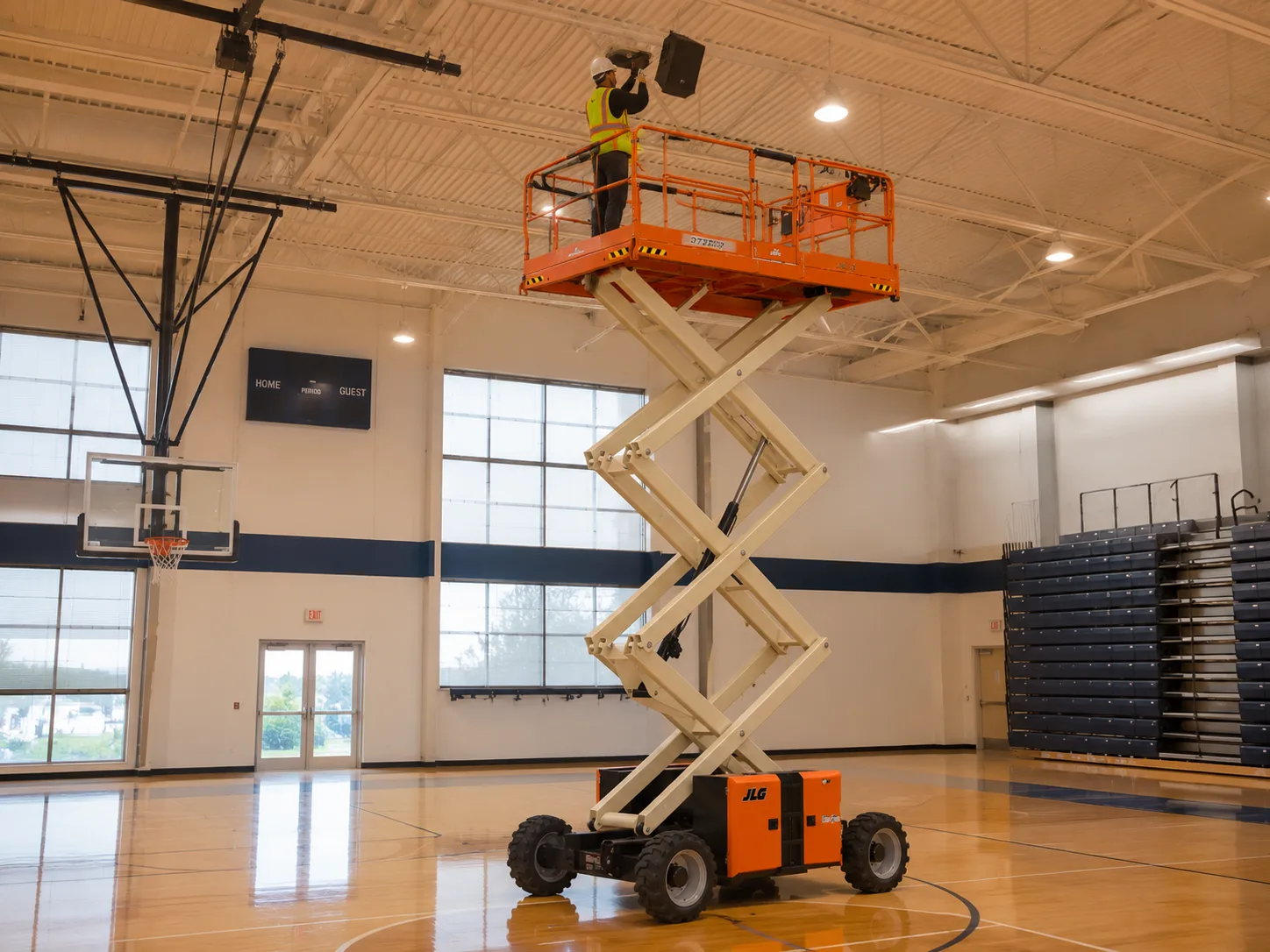 JLG scissor lift working at height indoors